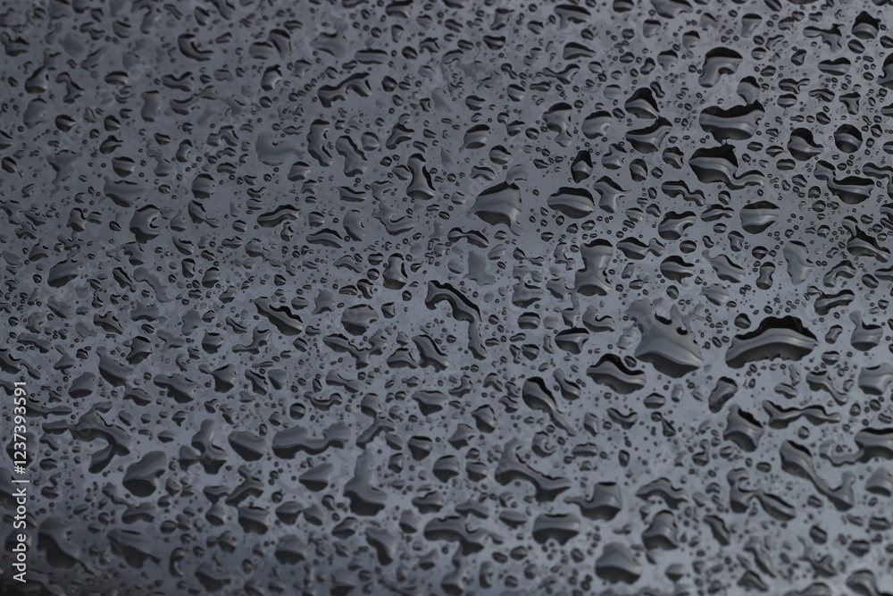 Water drops on grey glass surface, closeup Water drops on grey glass surface, closeup