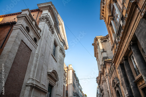 Photography Chiesa di Gesus e Maria, a historic Baroque church in old Rome, italy, on via del corso, stands prominently along a narrow street, highlighting the city’s deep Catholic heritage
