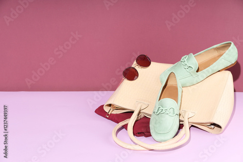 Clothes, shoes, bag and sunglasses on color background, space for text