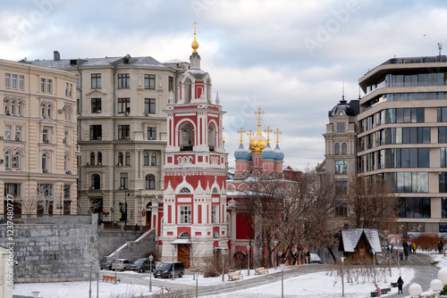 View of the Church of St. George the Victorious on Pskov Hill on Varvarka Street and Zaryadye Park on a snowy winter day, Moscow, Russia photo