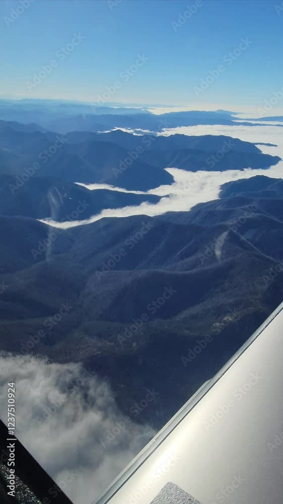 Aerial view from a small aircraft flying over Oregon’s central Cascade mountains. Snow-covered peaks, vast landscapes unfold in this dynamic 4K 60fps footage, captured en route from Aurora to Sunriver