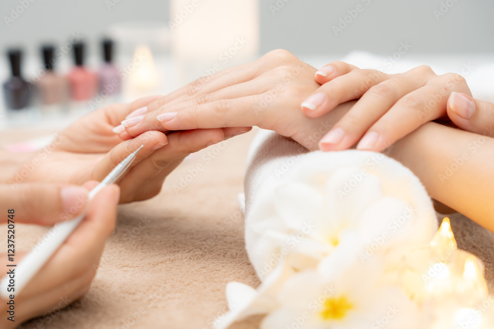 Fototapeta premium Woman receive care service by professional Beautician Manicure at spa centre. Nail beauty salon use nail file for Glazing treatment. manicurist make nail customer to beautiful. body care spa treatment