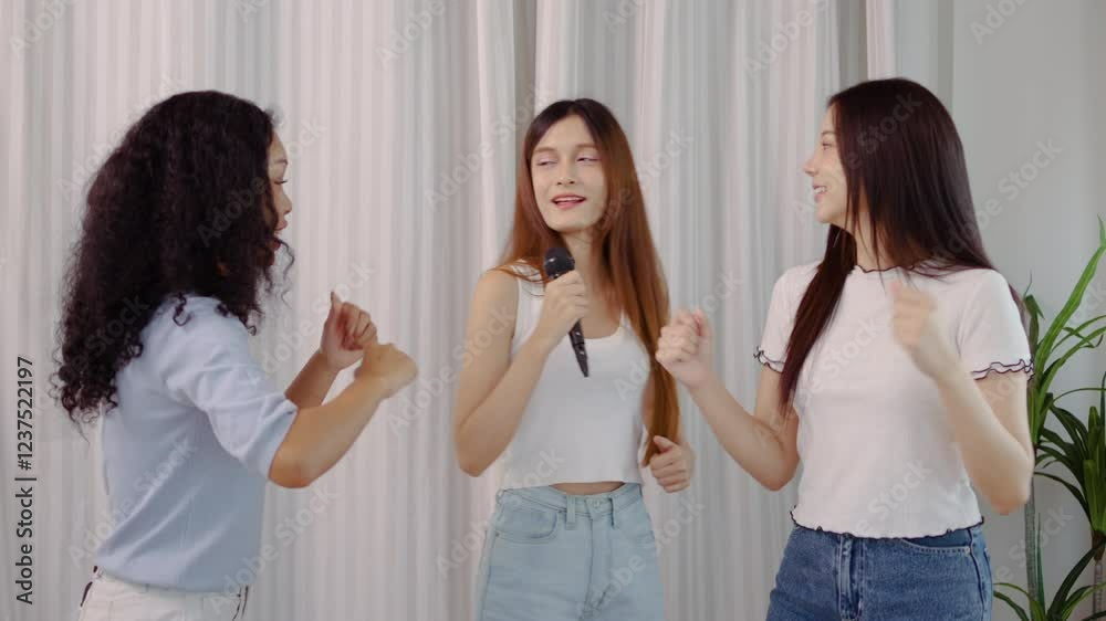 Cheerful three young asian and mixed race woman celebrate friendship as they sing and dance together with infectious enthusiasm, sharing laughter and joy, Dancer shows body wave and other movements Cheerful three young asian and mixed race woman celebrate friendship as they sing and dance together with infectious enthusiasm, sharing laughter and joy, Dancer shows body wave and other movements