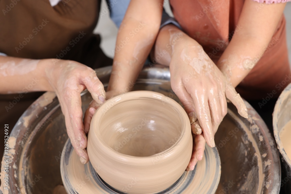 Hobby and craft. Mother with her daughter making pottery indoors, closeup Hobby and craft. Mother with her daughter making pottery indoors, closeup
