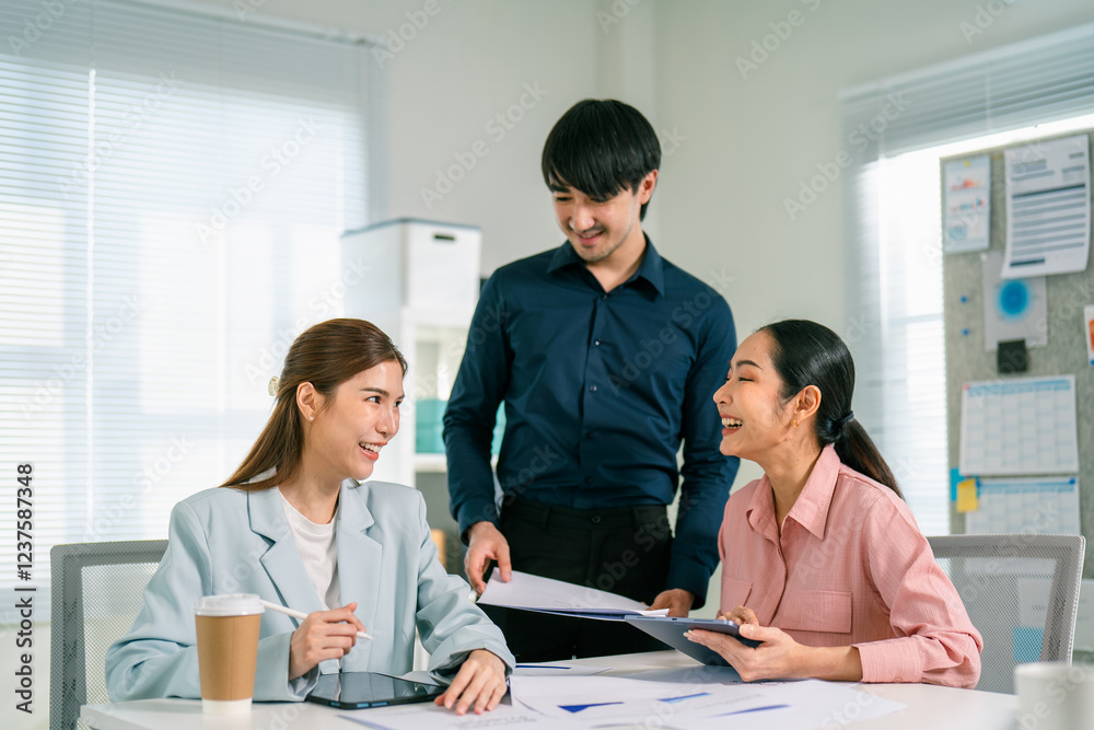 A group of three professionals collaborate in a bright office, discussing documents and sharing ideas, showcasing teamwork and engagement. A group of three professionals collaborate in a bright office, discussing documents and sharing ideas, showcasing teamwork and engagement.
