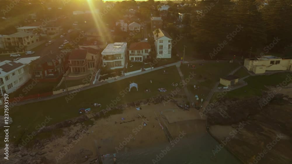 Aerial drone reverse view above Shelly Beach Ocean Pool in Cronulla in the Sutherland Shire, South Sydney, NSW Australia during late afternoon summer in February 2025   