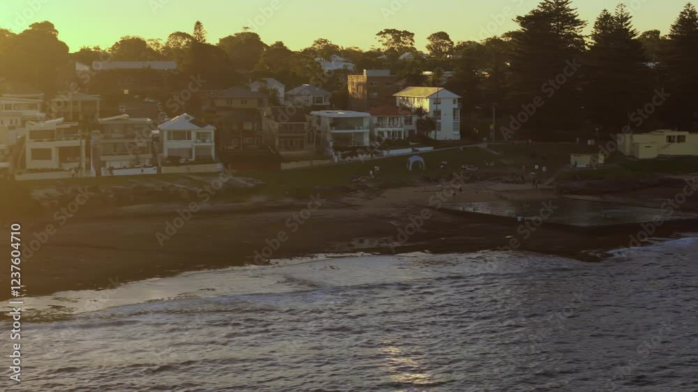 Aerial drone view past Shelly Beach Ocean Pool in Cronulla in the Sutherland Shire, South Sydney, NSW Australia during late afternoon summer in February 2025   