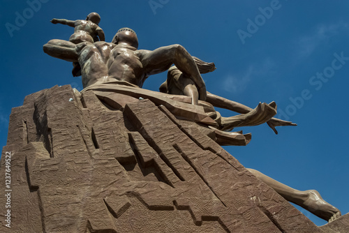 Dakar, Senegal – View of the African Renaissance Monument, a 52-meter (171 ft) tall bronze statue located atop one of the twin hills known as Collines des Mamelles, on the outskirts of Dakar. photo