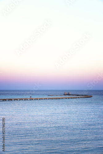 sea and colorful sky and a wandering trestle bridge