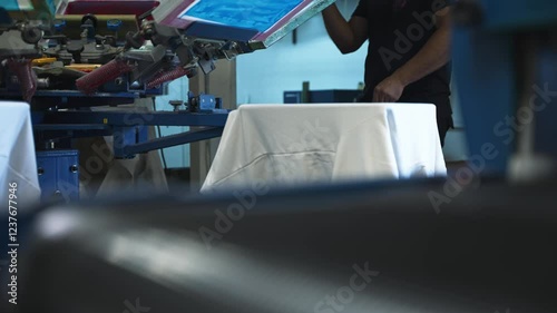 Medium abstract view of fabric moving through screenprinting machine rotating through layers, showcasing design application and vibrant details