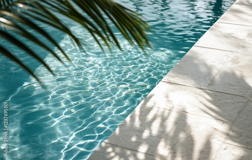 Relaxing view of shimmering pool with palm leaves in a sunny outdoor setting
