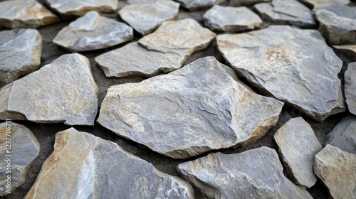 Grey stone wall texture, outdoor close-up, uneven surface, background blurred photo