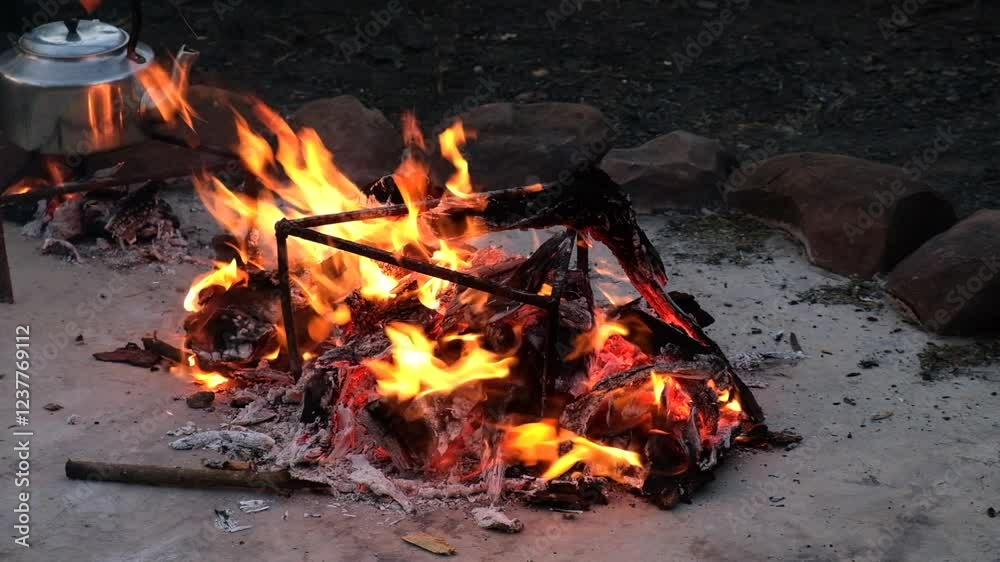 Roaring campfire with a kettle on a stand, set in Tugela Ferry, perfect for outdoor moments Roaring campfire with a kettle on a stand, set in Tugela Ferry, perfect for outdoor moments