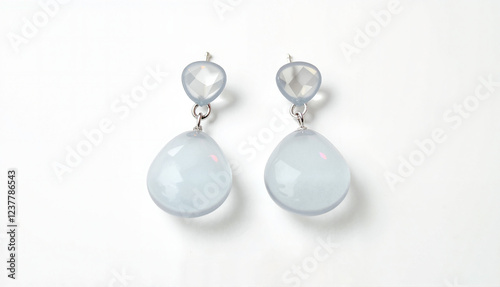 Elegant drop earrings with light blue gems on white background with copy space