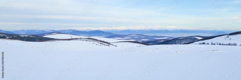 Obraz premium Snow-covered landscape with rolling hills and a distant mountain range in the background, winter, rolling hills, range