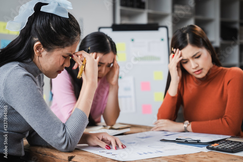 Asian people, frustrated businesswoman sits at desk, grappling with challenges of her startup, acknowledging failure, and seeking ways to learn and grow. team meeting. blamed