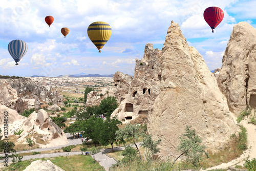 The balloon flight, famous tourist attraction of Cappadocia. Air balloons and Fairy Chimney (multihead stone mushrooms) in Pasabag Valley, Cappadocia, Anatolia, Turkey photo