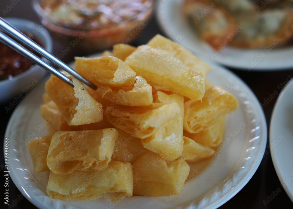 Tai yellow rectangular tofu, scored in the middle, and deep fried from Shan state, Myanmar Tai yellow rectangular tofu, scored in the middle, and deep fried from Shan state, Myanmar
