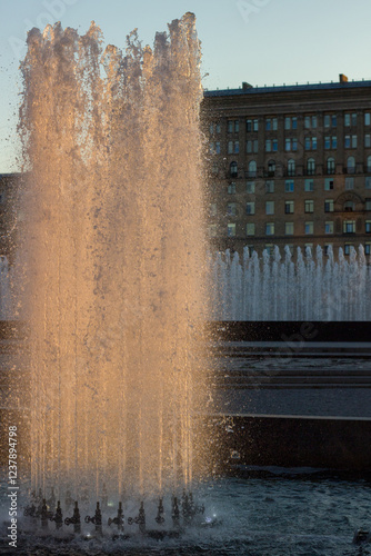 Orange sunset in a park with fountains photo