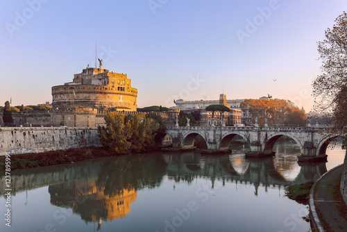 Rome in morning. Panoramic view of Castel Sant'Angelo and Bridge in Rome with reflection in Tiber river photo