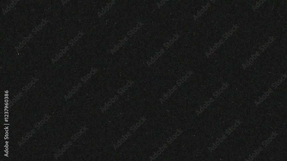 White scratches and roughness on a black screen. Effect of old film noise in 4K with alpha channel. Stock video with retro nostalgic effect.