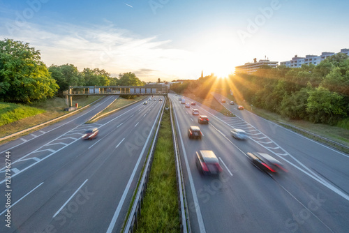 Cars moving in speed on highway at sunset photo