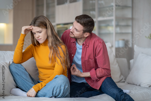 Fotografie Caring guy trying to explain justify to emotional girl
