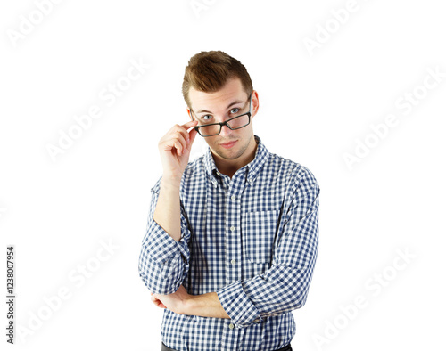 A young man wearing a blue checkered shirt, adjusting his glasses, isolated on a white background. Concept of thoughtful or inquisitive expression