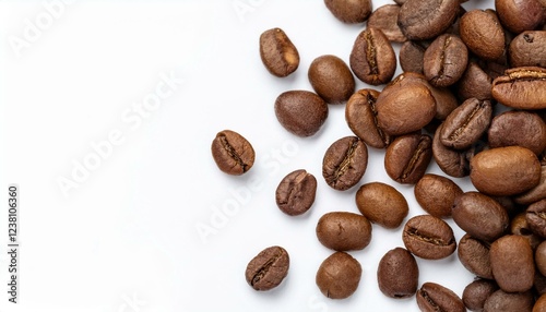 roasted coffee beans scattered on a surface. The beans are dark brown and have a rich, inviting aroma. The image evokes the smell of freshly brewed coffee and the warm.