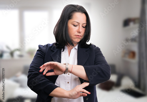 Businesswoman getting ready for work checking wrist watch