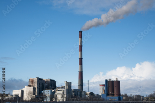 Obraz na płótnie A coal-fired power plant emits greenhouse gases into the atmosphere.
w salonie