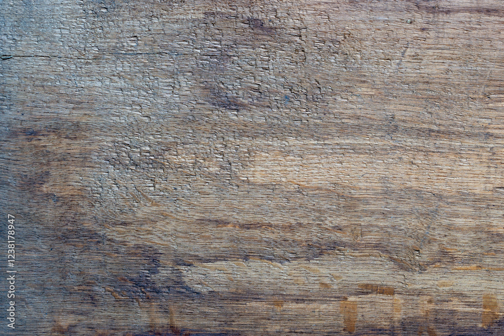 The old wooden plank is weathered, cracked, and rough.