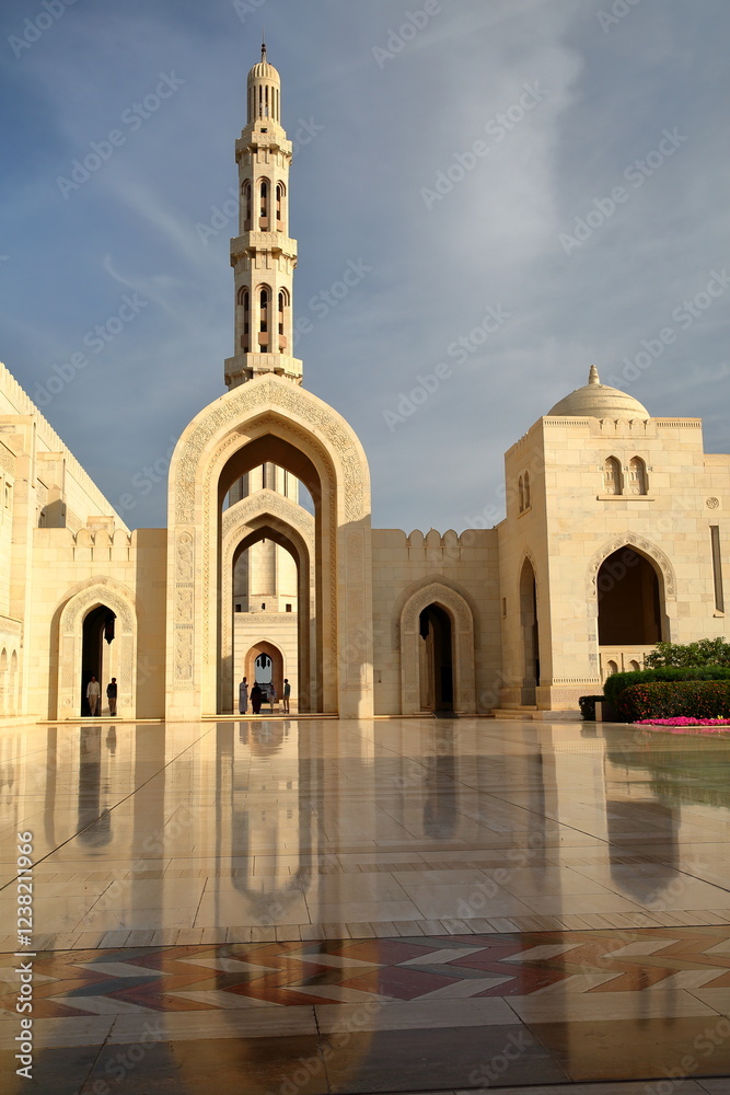 The Sultan Qaboos Grand Mosque in Muscat, Oman, with patterned tiles and reflections
