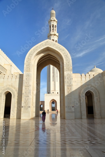 The Sultan Qaboos Grand Mosque in Muscat, Oman, with arches and the minaret