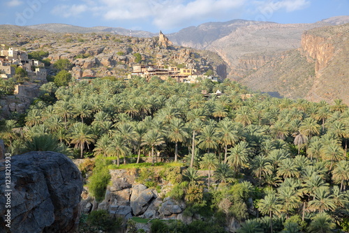 General view of the mountain village Misfat Al Abryeen, Jebel Shams, Al Dakhiliyah, Oman, surrounded by terraced palm grove and mountains photo