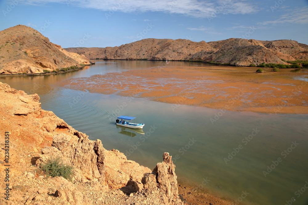 The Fjords of Bandar Al Khairan, located 30 km East from Muscat, Oman, with desert landscape, clear and colorful water, beaches and rocky mountains