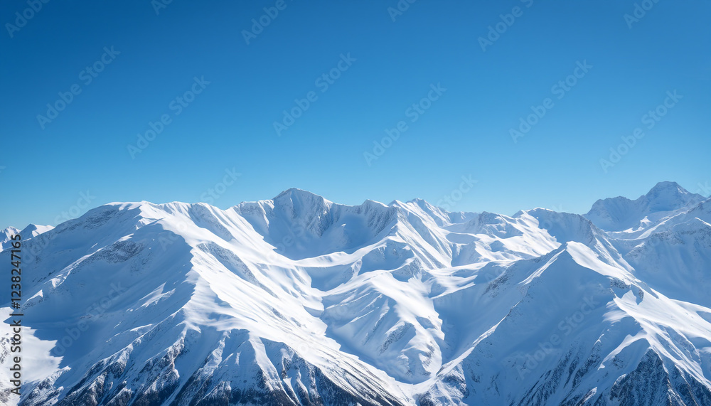 A stunning view of a snow-covered mountain range under a bright blue sky, capturing the peaceful and breathtaking beauty of winter, with untouched white peaks creating a serene and majestic landscape. A stunning view of a snow-covered mountain range under a bright blue sky, capturing the peaceful and breathtaking beauty of winter, with untouched white peaks creating a serene and majestic landscape.