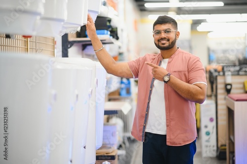 Indian Plumber with boilers, plumbering store. photo