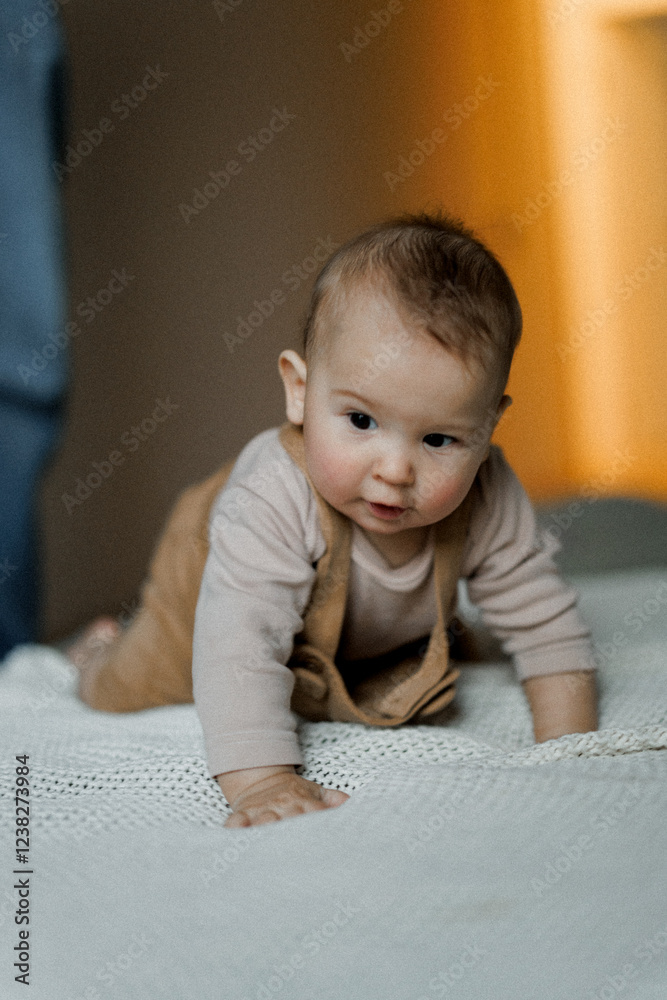 homemade photos of a cute little boy taken in his parents' bedroom when he is playing with mom and dad lying on the bed homemade photos of a cute little boy taken in his parents' bedroom when he is playing with mom and dad lying on the bed