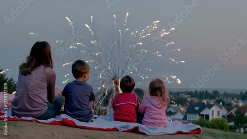 Family Watching Fireworks on Hilltop