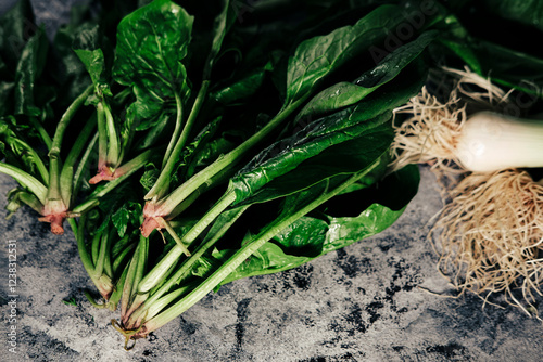 pile of fresh spinach leaves with roots, clean  from garden or farm market photo