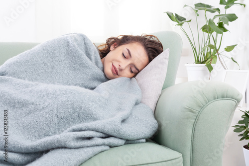 smiling serene woman sleeping on cozy sofa under warm soft plaid blanket in living room. Healthy daytime napping, tiredness relief, repose and relaxation during day, stress-free lazy weekend at home