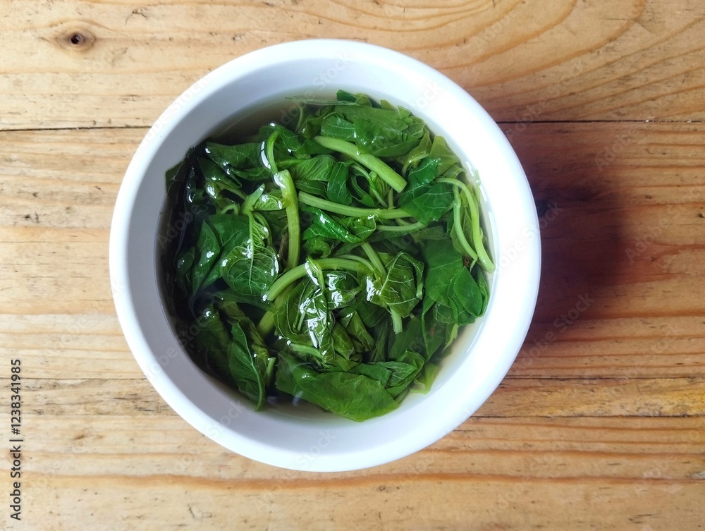 Spinach soup in bowl on wooden table background, Vegetarian cuisine Spinach soup in bowl on wooden table background, Vegetarian cuisine