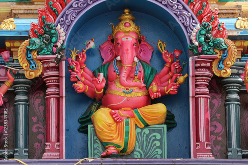 Photography The multi-armed god Ganesha on the roof of a Hindu temple.