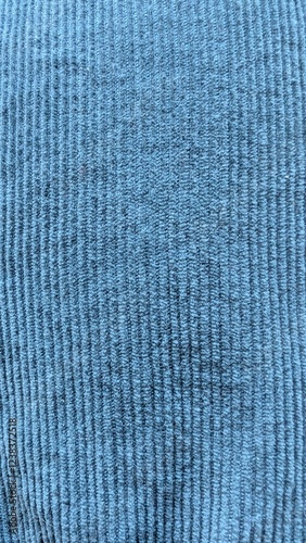 Teal corduroy fabric. Close-up turquoise clothes. Textile texture pattern.