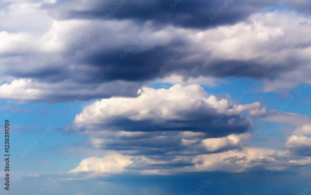 Clouds of various shapes and tones spread across vibrant blue sky, showcasing dynamic cloud formations and contrasting light and shadow, beauty and serenity weather patterns. Selective focus, defocus Clouds of various shapes and tones spread across vibrant blue sky, showcasing dynamic cloud formations and contrasting light and shadow, beauty and serenity weather patterns. Selective focus, defocus