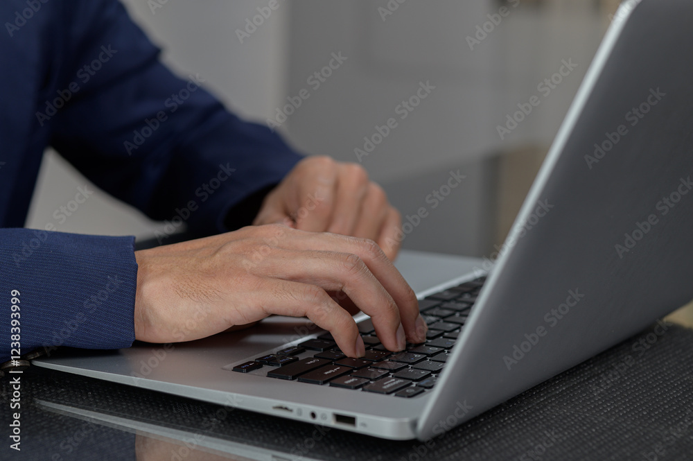 Close-up of Hands Typing on Laptop Keyboard in Modern Workspace Close-up of Hands Typing on Laptop Keyboard in Modern Workspace