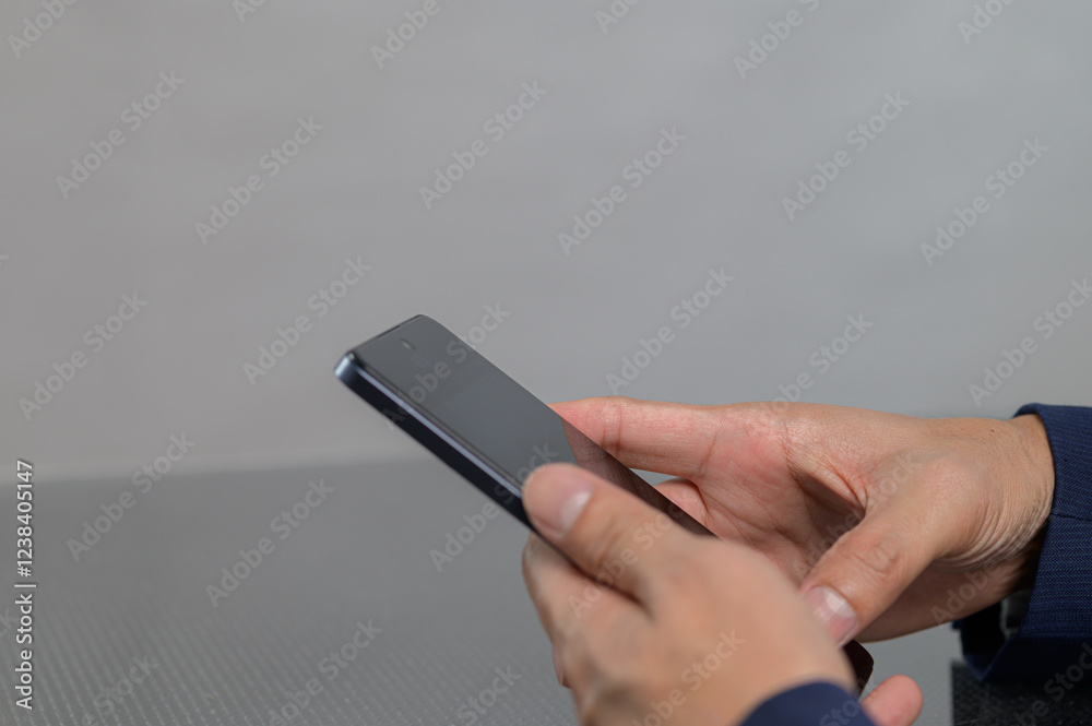 Person Using Smartphone in Hands with Gray Background Person Using Smartphone in Hands with Gray Background
