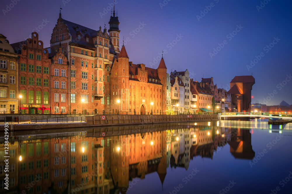 Beautiful architecture of the old town in Gdansk by the Motława river with a historic port crane at wintery night. Poland Beautiful architecture of the old town in Gdansk by the Motława river with a historic port crane at wintery night. Poland