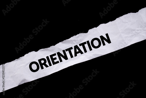 Orientation message written on ripped torn white paper on black background. Conceptual orientation symbol. Copy space.
